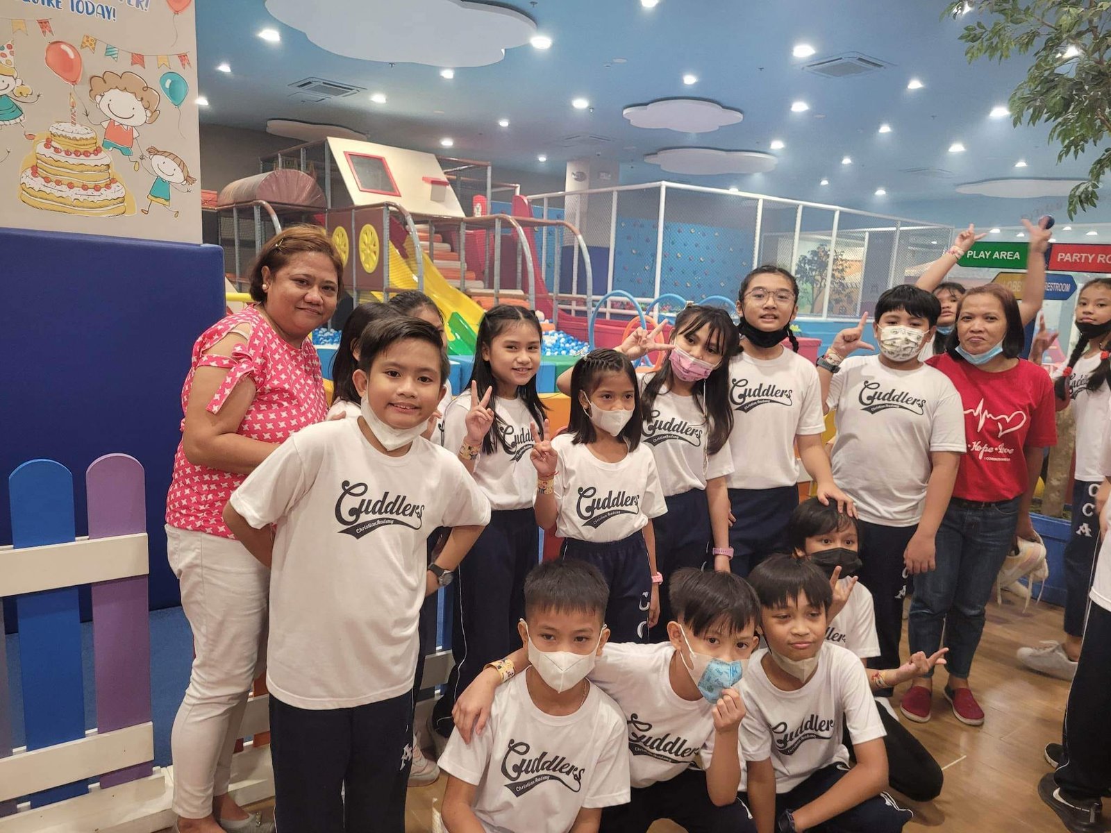 Diverse group of students engaged in online learning on laptops and tablets